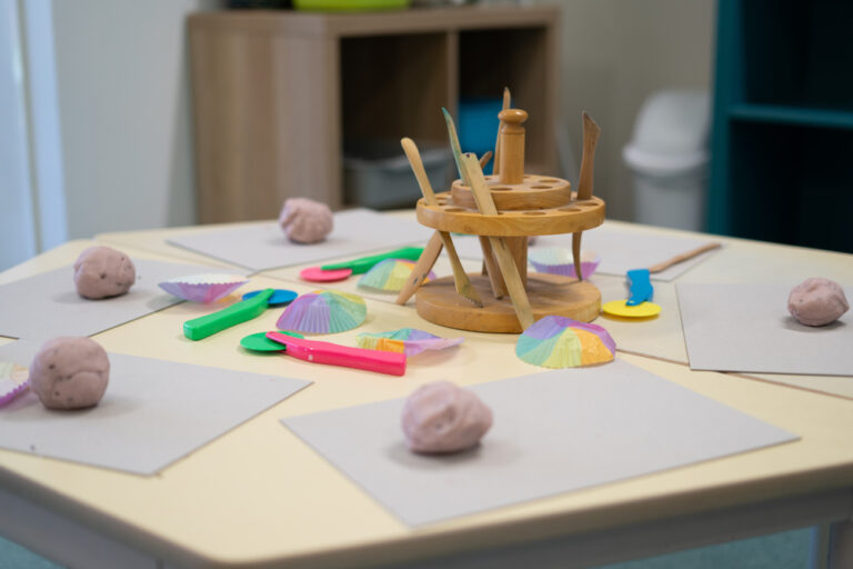 Playdough and craft tools set out on a table for children