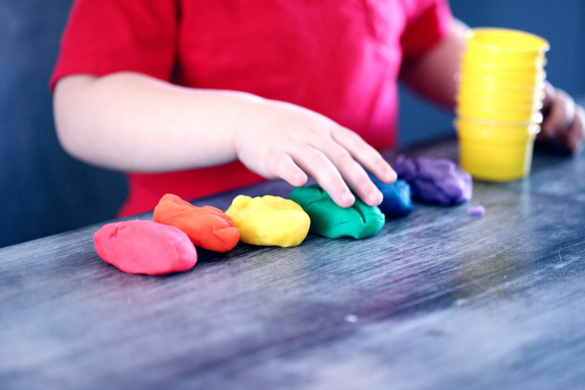 child having fun with playdough - -early learning