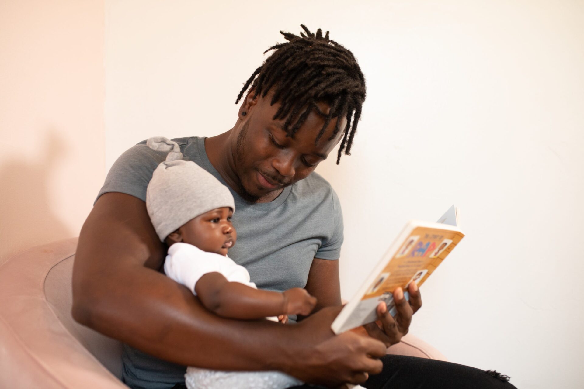 Father holding baby and reading a picture book