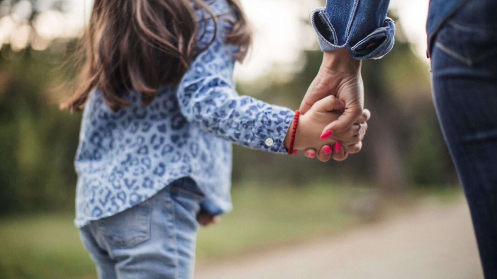 child and mother walking outside