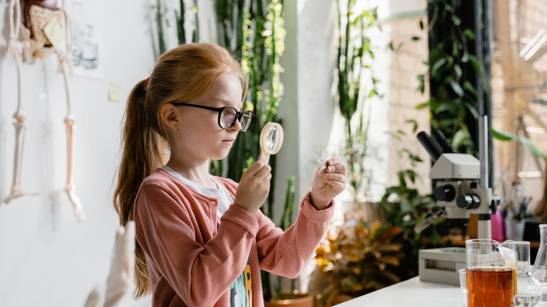 child holding magnifying glass