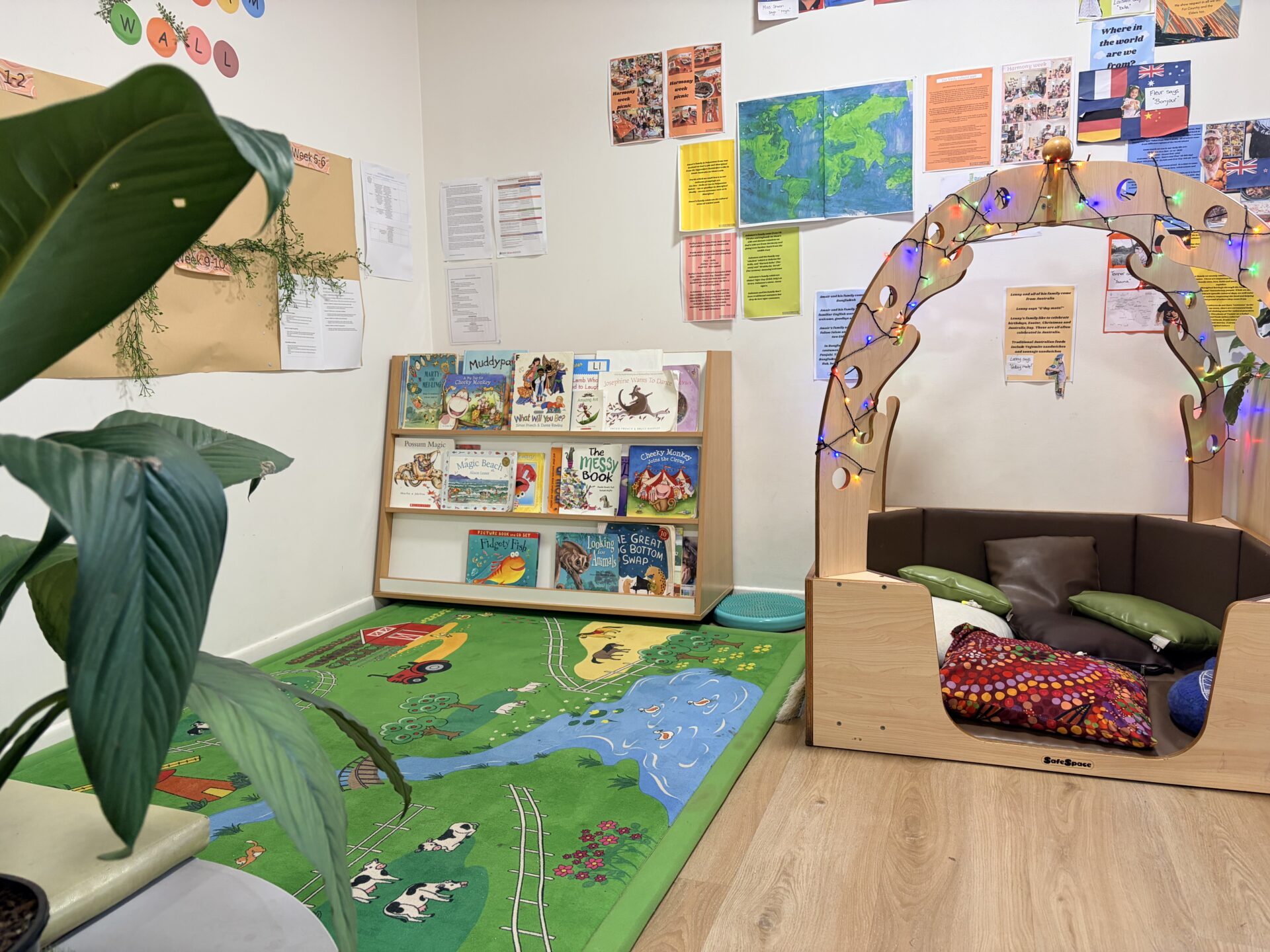 A cosy reading corner with an armchair and shelf at the centre