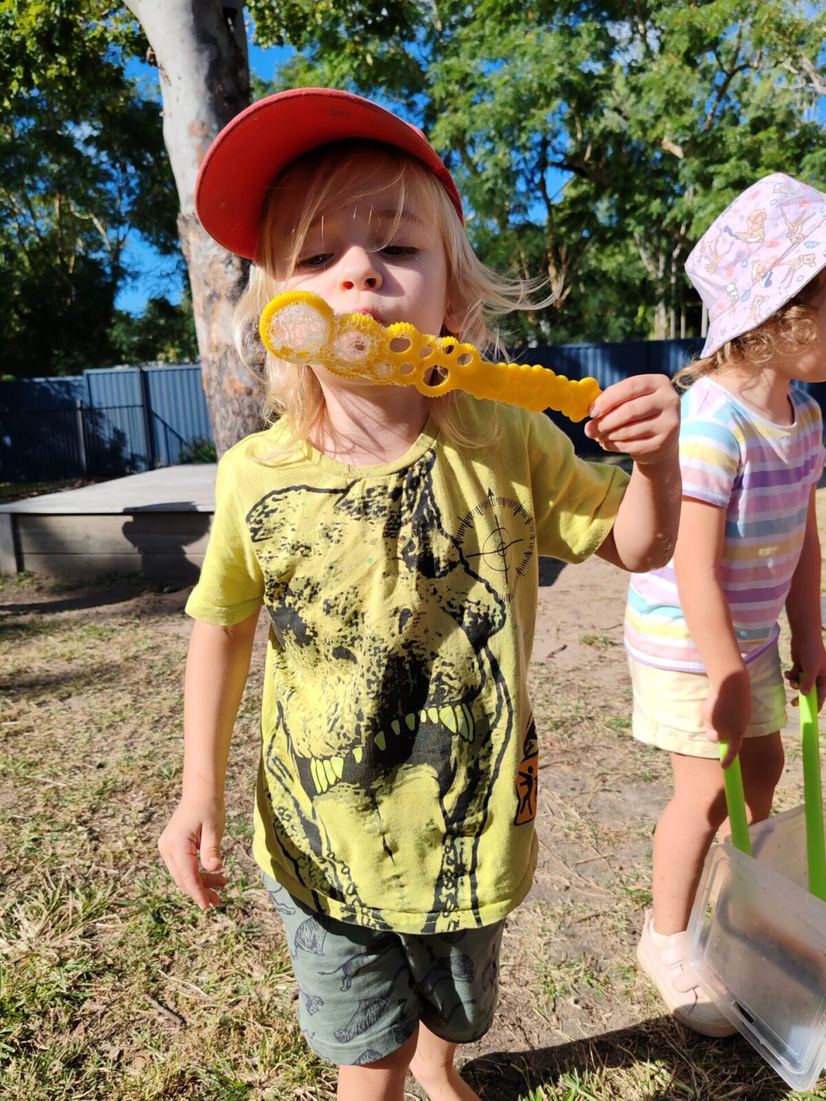 Child blowing bubbles outdoors at Arden Early Learning Airlie Beach