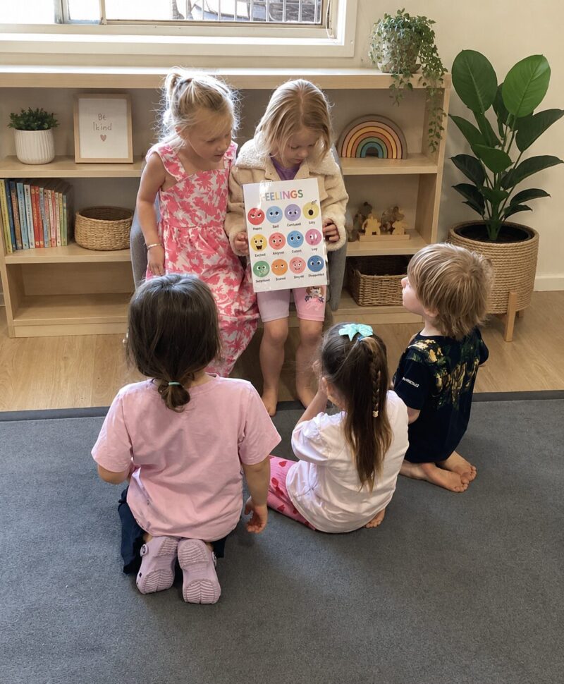Kindergarten children sharing a feelings chart together at Arden Early Learning Airlie Beach
