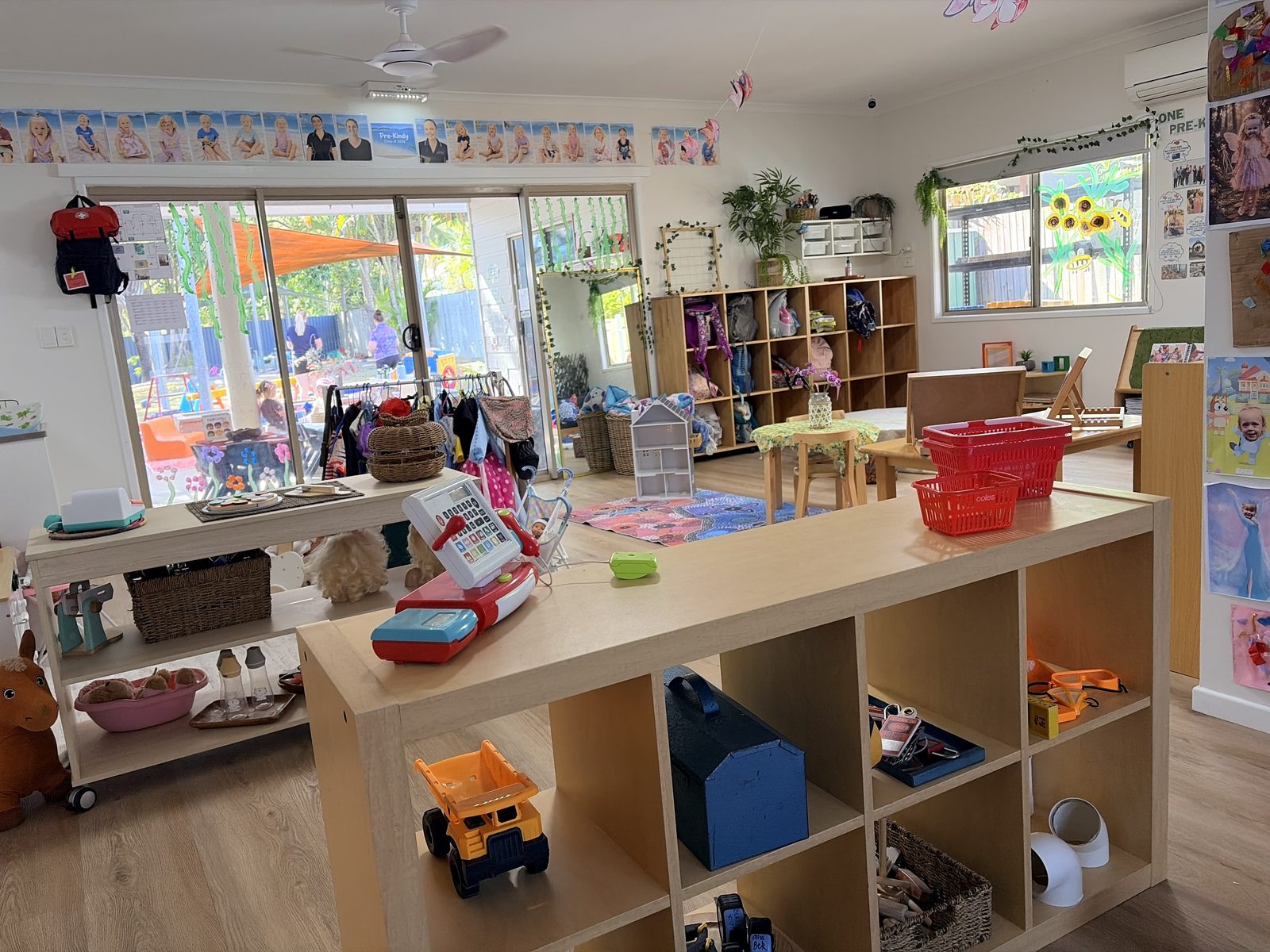 The pretend marketplace and cubby space in the Pre-Kindy room