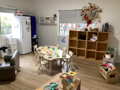 A toddler painting during craft time at Arden Early Learning